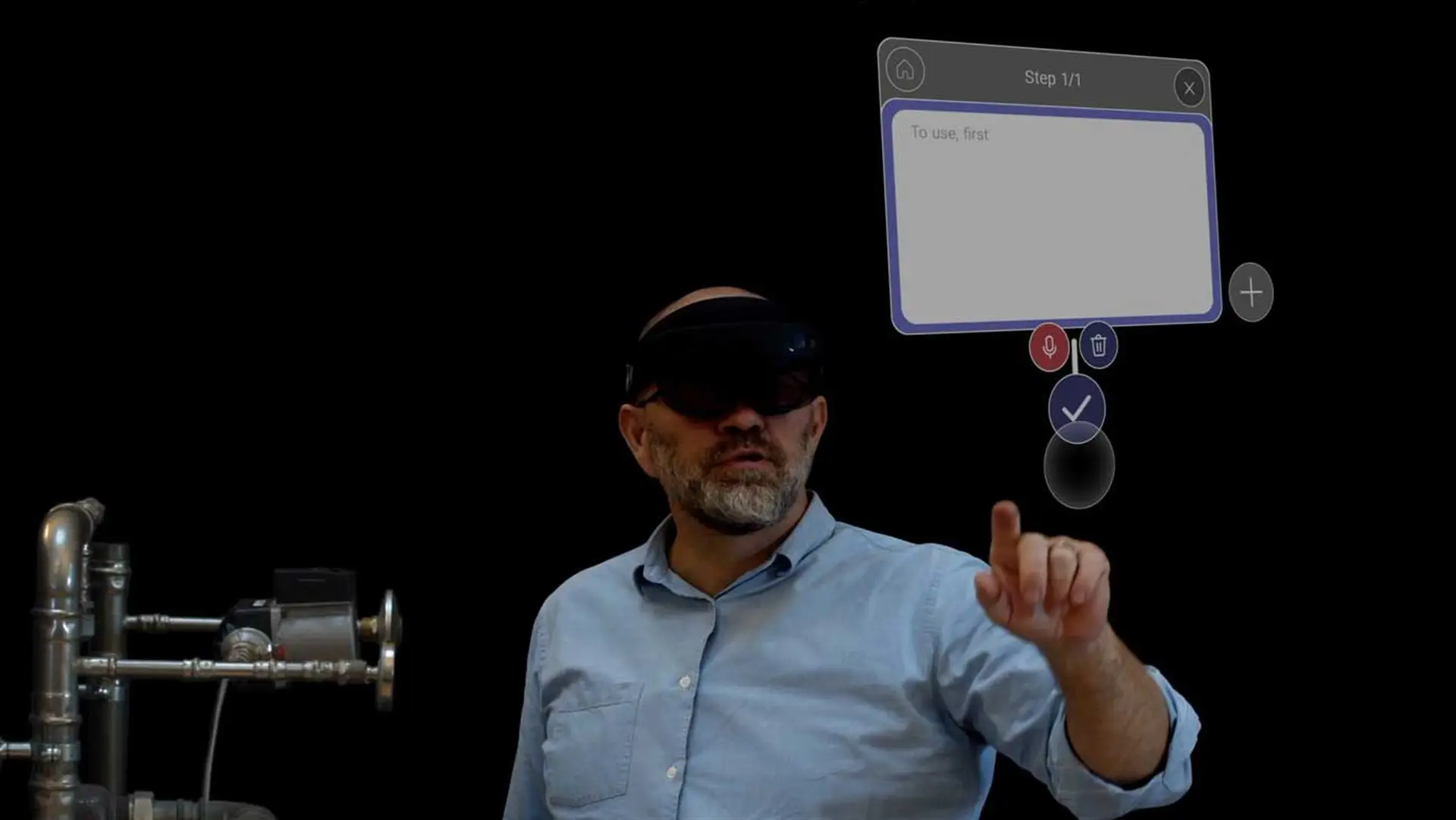 Image of a user demonstrating the Tutorio Mixed Reality application on HoloLens, interacting with a spatially anchored step interface for workspace instructions.