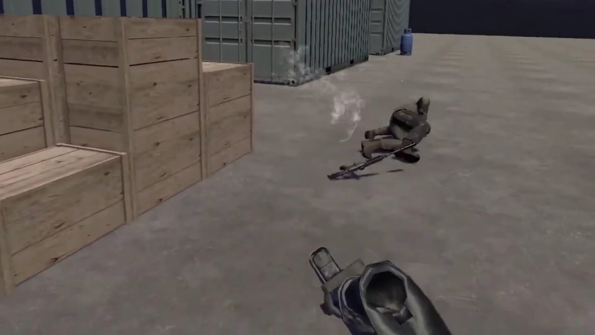 Incapacitated enemy dropping their weapon, while the player holds a lowered weapon in the same environment as image 2.